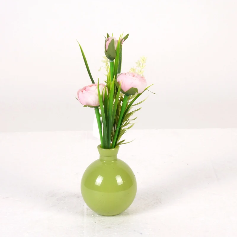 Ranunculus in green glass vase H22cm pink